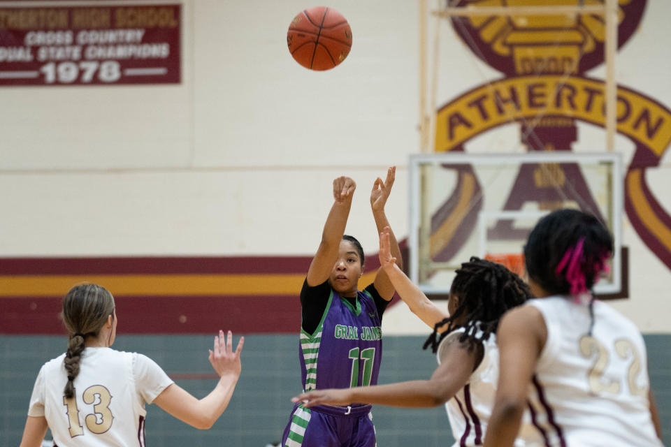 Grace James' Faith Mosley makes a 3-pointer against Atherton. Mosley, an eighth grader, is averaging about 19 points a game this season.