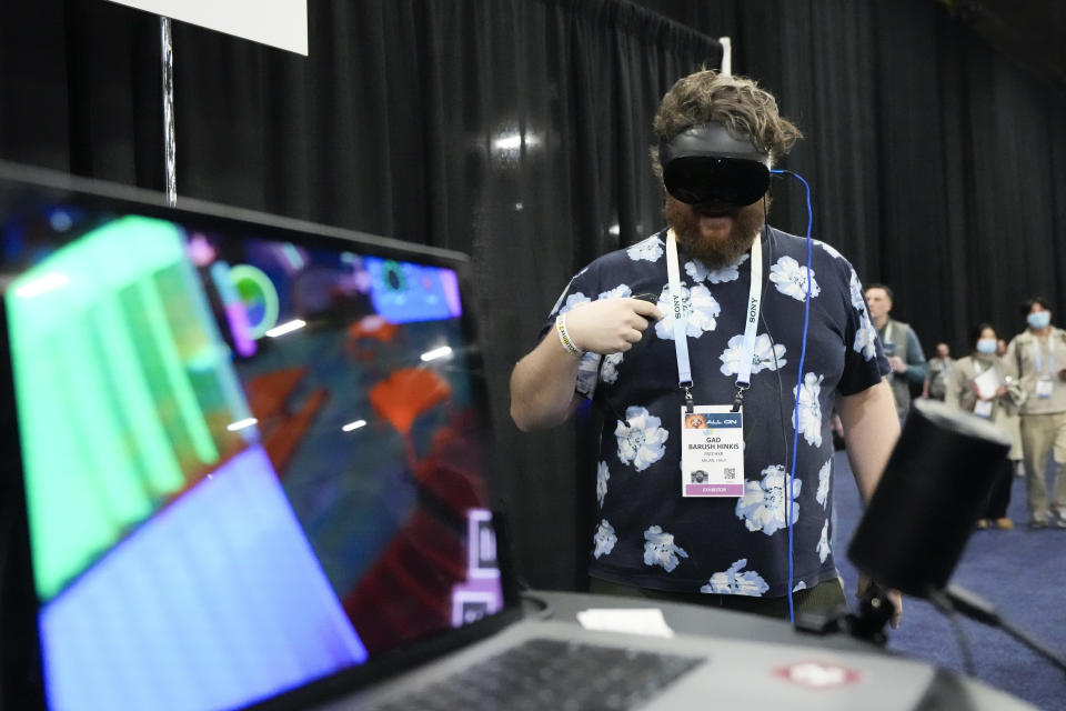 Gad Baruch Hinkis, of PatchXR, demonstrates the PatchWorld program during CES Unveiled before the start of the CES tech show Sunday, Jan. 7, 2024, in Las Vegas. PatchWorld is an augmented reality gaming platform that allows users to create virtual building blocks for music. (AP Photo/Ryan Sun)