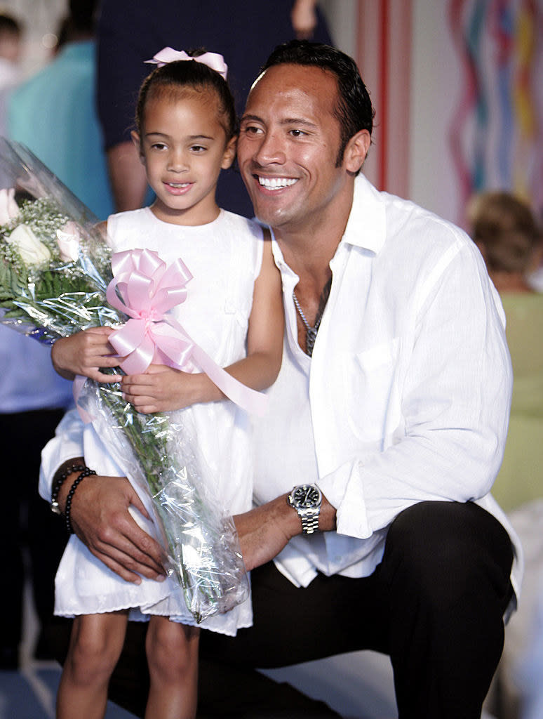 the rock is hugging simone and she's like 5