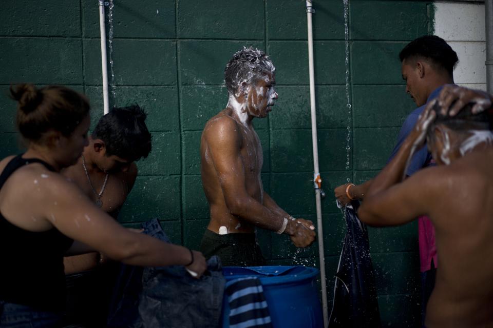 Migrants, part of the migrant caravan, take a bath at a sports complex where more than 5,000 Central American migrants are sheltering in Tijuana, Mexico, Wednesday, Nov. 28, 2018. As Mexico wrestles with what to do with the thousands of people camped out in the border city of Tijuana, President-elect Andres Manuel Lopez Obrador's government signaled that it would be willing to house the migrants on Mexican soil while they apply for asylum in the United States, a key demand of U.S. President Donald Trump. (AP Photo/Ramon Espinosa)