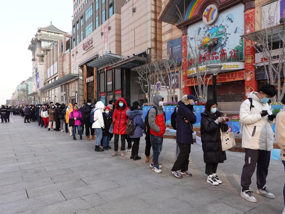 People wait in lines outside of flagship merchandise store for Beijing 2022 Winter Olympics on Wangfujing Street on February 9, 2022 in Beijing, China. Beijing 2022 mascot Bing Dwen Dwen become popular during the ongoing Beijing Winter Games.