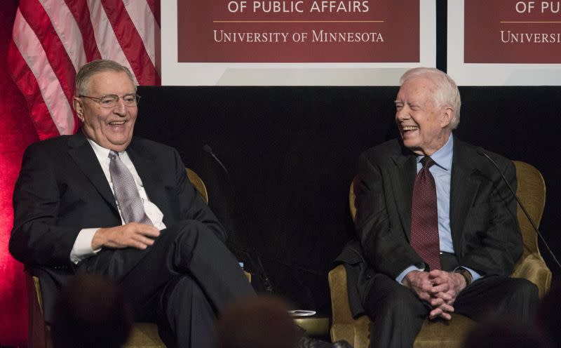 FILE PHOTO: Former U.S. President Jimmy Carter laughs with former U.S. Vice President Walter Mondale in Washington