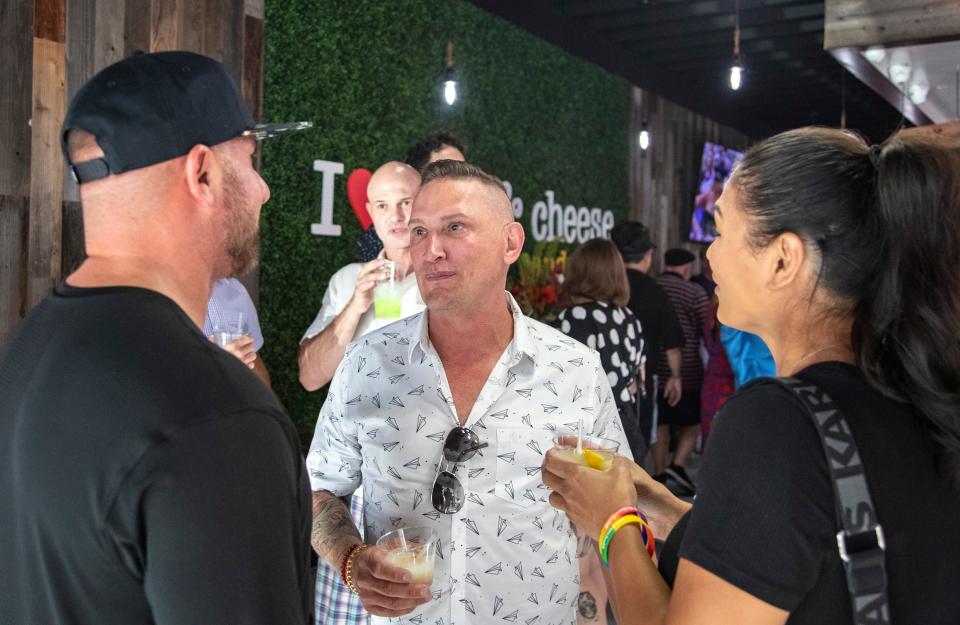 Owner Blu Bryan speaks to guests during a VIP grand opening celebration at I Heart Mac & Cheese in Palm Springs, Calif., Tuesday, June 28, 2022. 