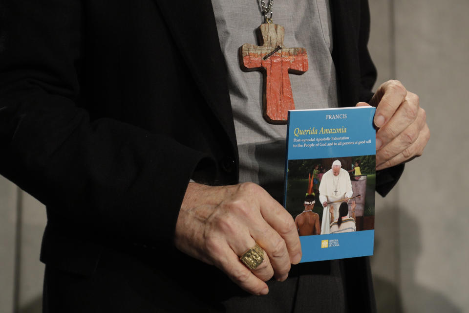 Cardinal Michael Czerny holds a copy of the post-synodal apostolic exhortation "Querida Amazonia" written by Pope Francis during a press conference at the Vatican, Wednesday, Feb. 12, 2020. (AP Photo/Gregorio Borgia)