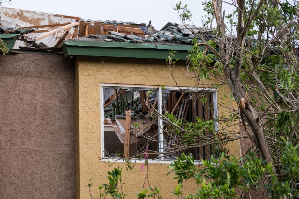 Blown-out windows and destroyed roof on a condemned building at the Sanctuary Cove Apartment complex in North Palm Beach on Sunday.