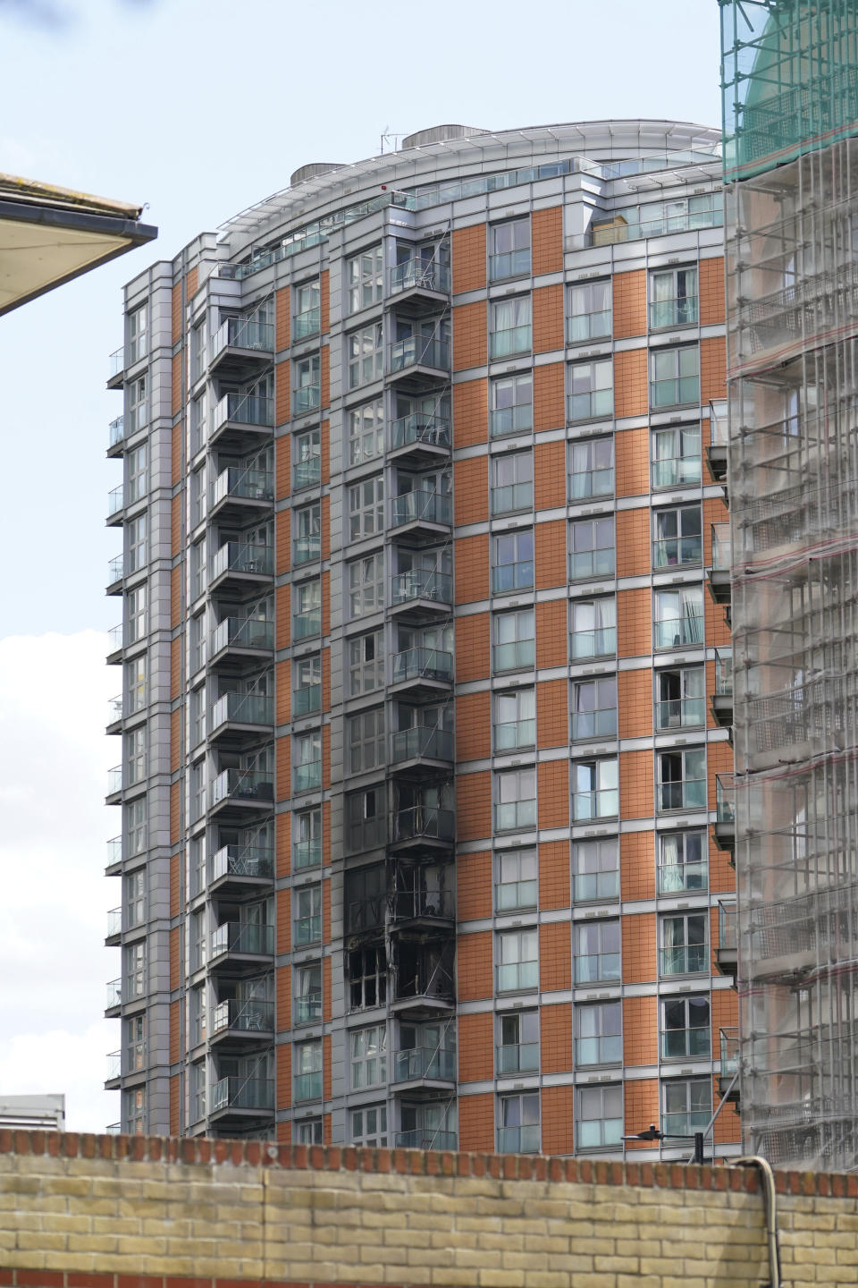 Damage to a 19-storey tower block in New Providence Wharf in London, Friday, May 7, 2021. Firefighters have tacked a blaze in a London apartment tower that has cladding similar to that used on a building where 72 people died in 2017. London Fire Brigade said about 125 firefighters tackled a fire on Friday that spread to three floors of a 19-story building in the city’s docklands. (Yui Mok/PA via AP)