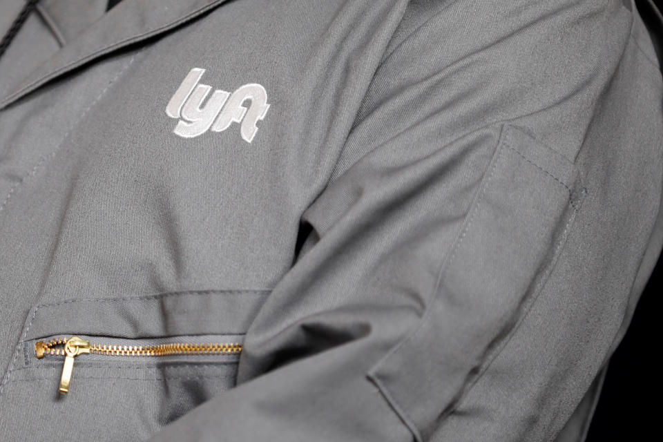 The Lyft logo is shown on an employees uniform as the company is listed on the Nasdaq at an IPO event in Los Angeles, California, U.S. March 29, 2019. REUTERS/Mike Blake