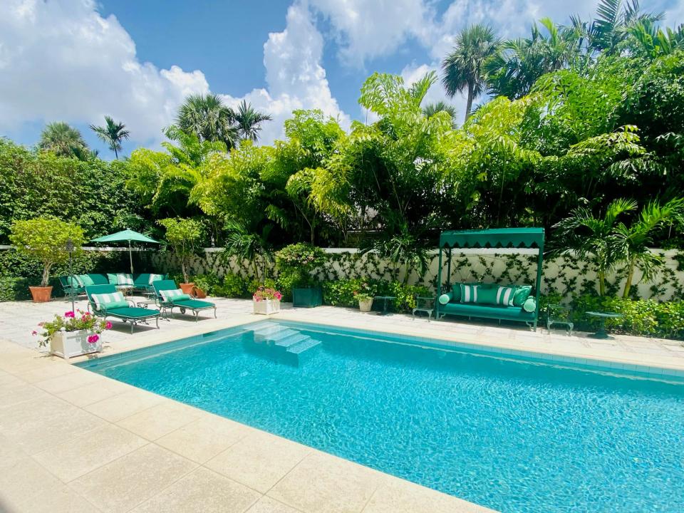 The pool is set into a patio area behind a Palm Beach house at 153 Kings Road, which is listed for sale at $18.95 million by Bob Jackson Inc.
