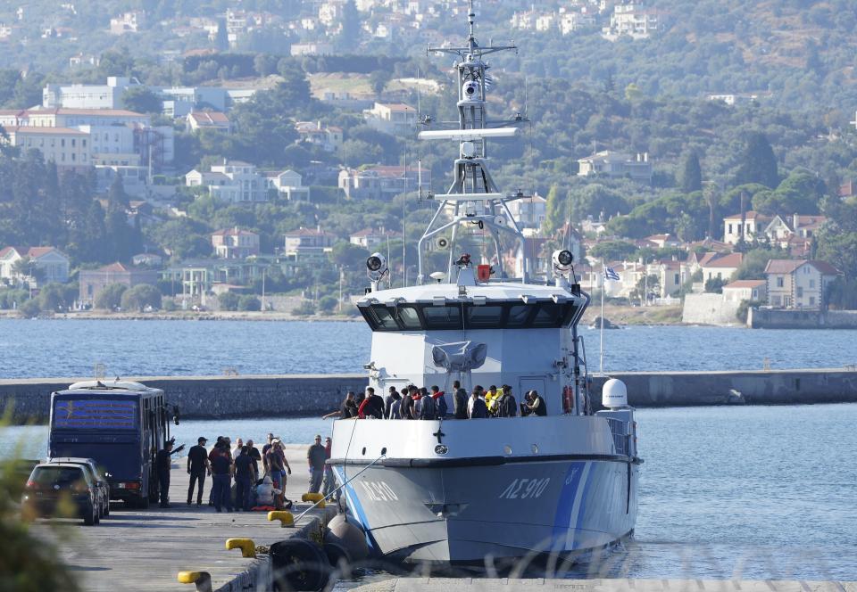 Migrants disembark from a Greek coast vessel after a rescue operation, at the port of Mytilene, on the northeastern Aegean Sea island of Lesbos, Greece, Monday, Aug. 28, 2023. Greek authorities say four people died and 18 were rescued Monday after a boat carrying migrants apparently sank northeast of the Greek island of Lesbos, which lies near the Turkish coast. (AP Photo/Panagiotis Balaskas)