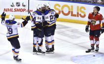 St. Louis Blues center Logan Brown (22) celebrates a goal with teammates as Florida Panthers defenseman Brandon Montour (62) looks on during the first period of an NHL hockey game Saturday, Dec. 4, 2021, in Sunrise, Fla. (AP Photo/Jim Rassol)