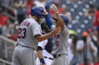 New York Mets' Francisco Lindor (12) celebrates his two-run home run with David Peterson (23) during the fifth inning of the first baseball game of a doubleheader against the Washington Nationals, Saturday, June 19, 2021, in Washington. This is a makeup of a postponed game from April 1. (AP Photo/Nick Wass)