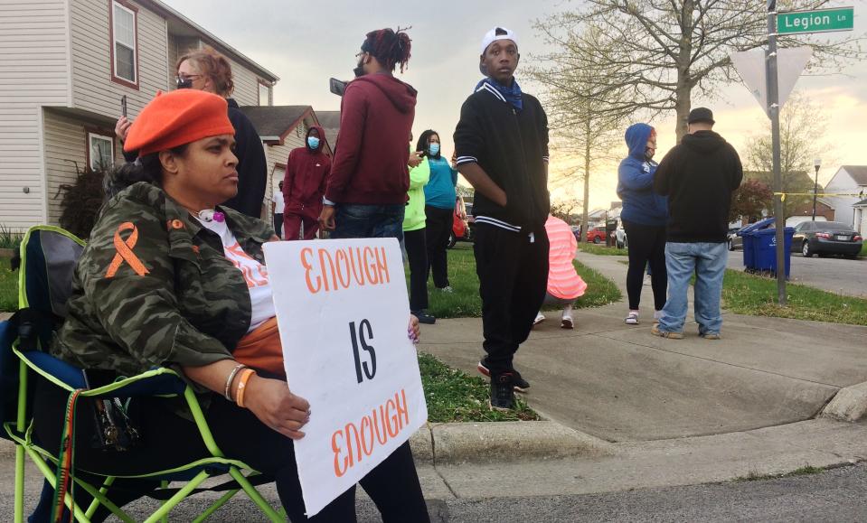 Malisa Thomas-St. Clair, with Mothers of Murdered Columbus Children, sits outside the scene of a police shooting near Legion Lane on Columbus' Southeast Side.