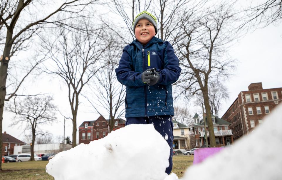 Daniel Ramos Aranda, 7, plays with the snow during the 2023 Clark Park Winter Carnival at the Clark Park Coalition in southwest Detroit on Saturday, Jan. 21, 2023. 