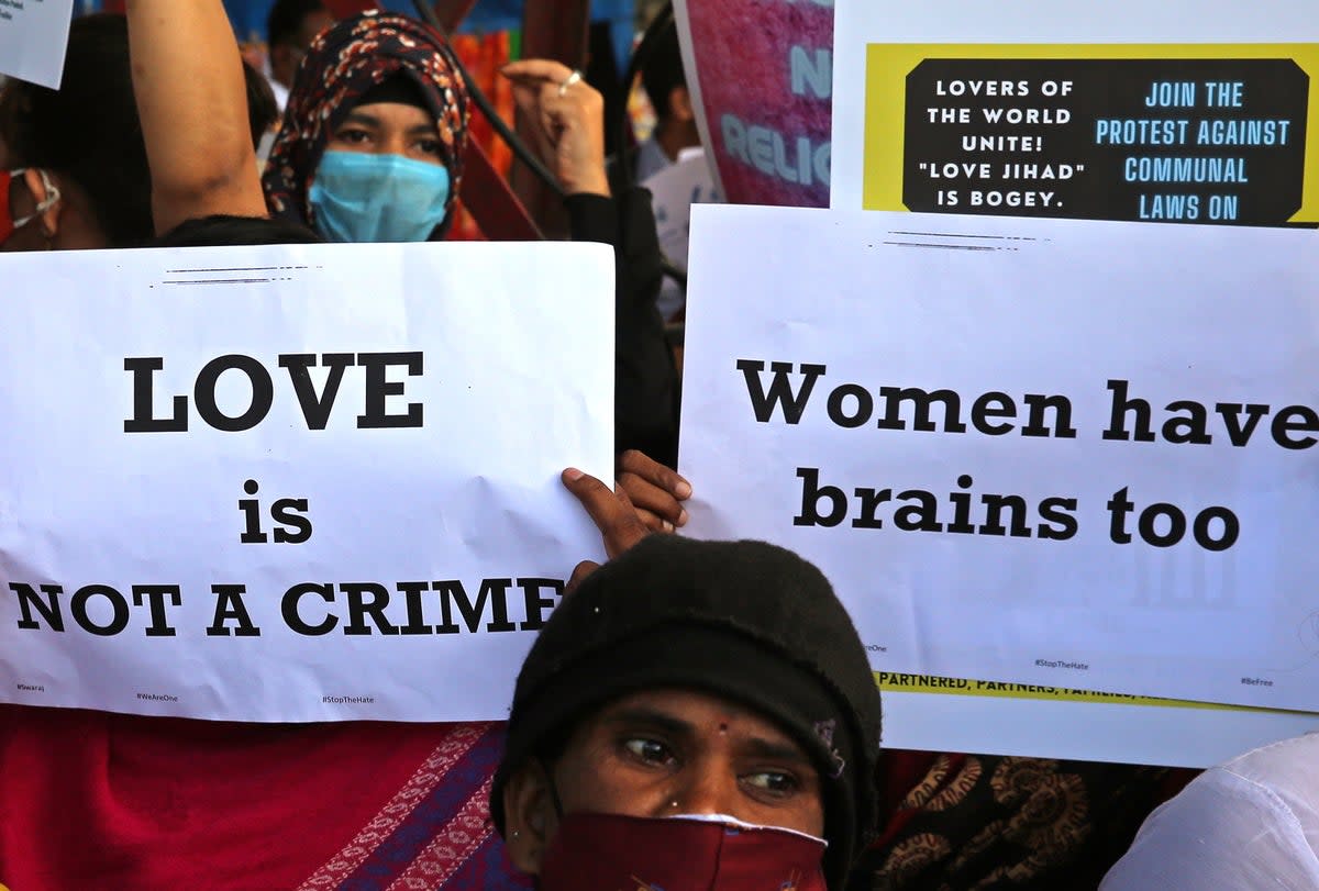 File: People from different human rights organizations hold placards during a protest against the BJP over a so-called 'love jihad' law, in Bengaluru, India (EPA)