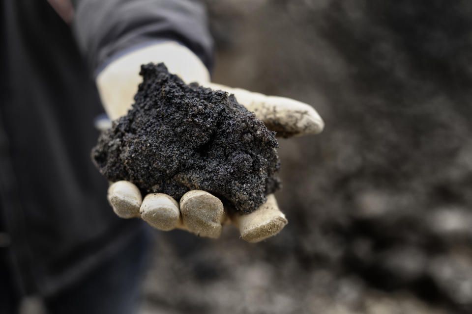 A handful of black oil rich sand from Alberta Canada.(GETTY)