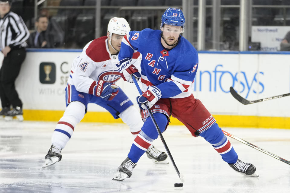 New York Rangers left wing Alexis Lafrenière (13) skates against Montreal Canadiens center Nick Suzuki (14) during the second period of an NHL hockey game, Sunday, April 7, 2024, at Madison Square Garden in New York. (AP Photo/Mary Altaffer)