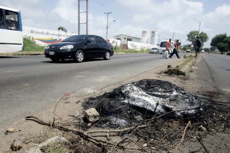 The remains of a police motorcycle burned by protestors, after a twelve-year-old boy was killed during a demonstration, is seen in San Felix, Venezuela, July 17, 2017. REUTERS/William Urdaneta