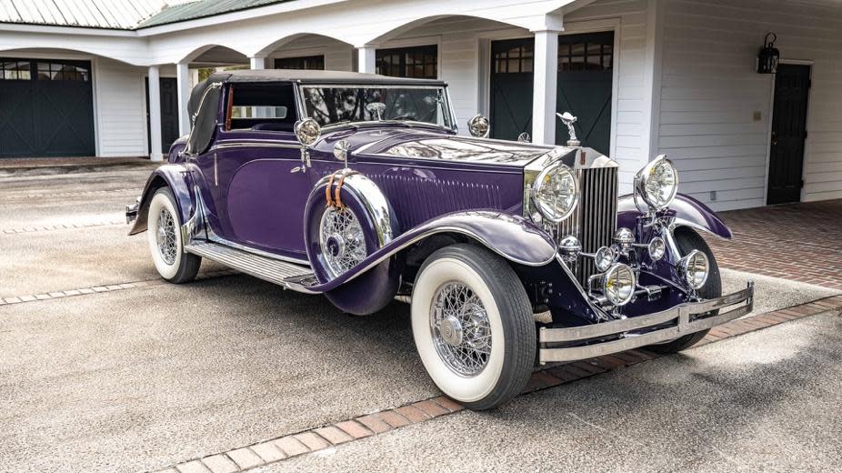 A purple car parked in front of a house

Description automatically generated