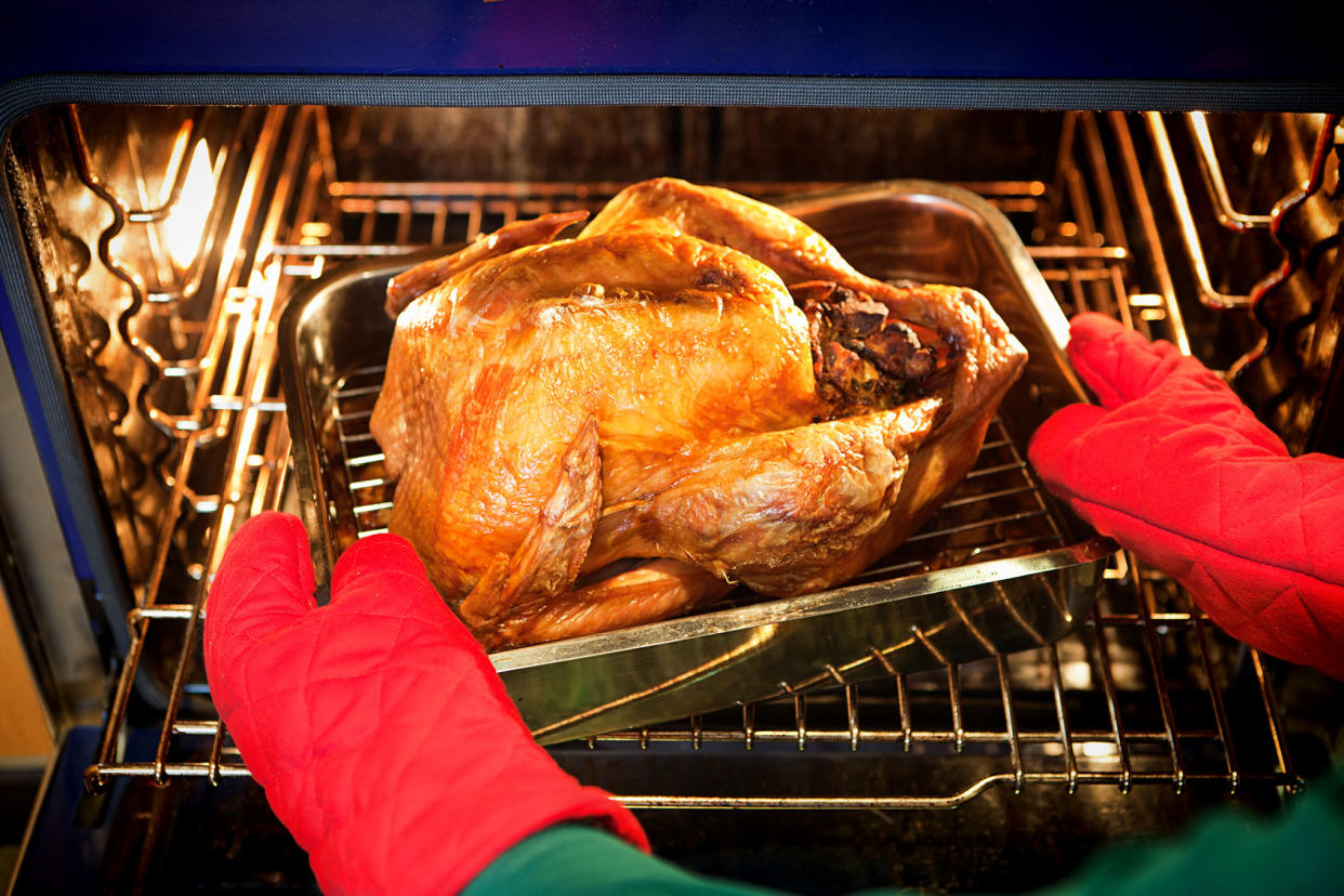 Freshly roasted turkey with stuffing coming out of the oven Getty Images/YinYang