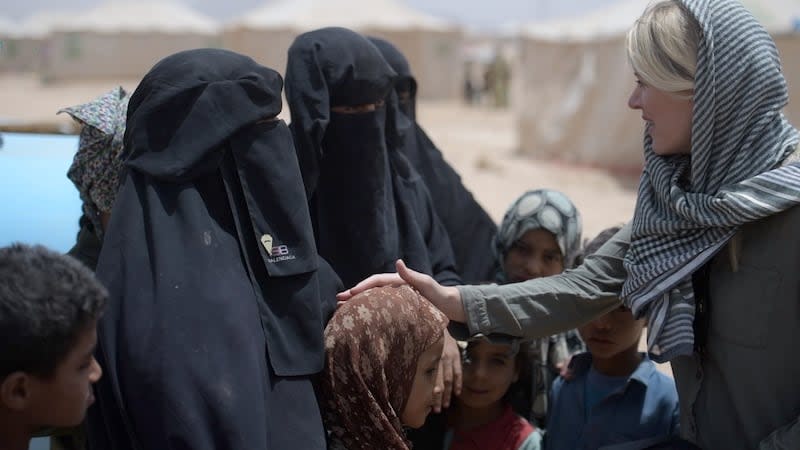 The author talking to Yemeni children in a camp just outside Marib, Yemen, in March 2021, after their displacement. According to her reporting, most she spoke with didn't remember a time before war.