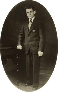 Black and white portrait of a boy in a suit.