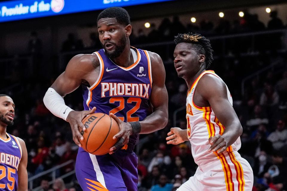 Feb 3, 2022; Atlanta, Georgia, USA; Phoenix Suns center Deandre Ayton (22) controls a rebound in front of Atlanta Hawks center Clint Capela (15) during the first half at State Farm Arena. Mandatory Credit: Dale Zanine-USA TODAY Sports