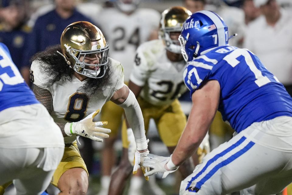 Sep 30, 2023; Durham, North Carolina, USA; Notre Dame Fighting Irish linebacker Marist Liufau (8) fends off a block by Duke Blue Devils offensive lineman Justin Pickett (77) during the second half at Wallace Wade Stadium. Mandatory Credit: Jim Dedmon-USA TODAY Sports