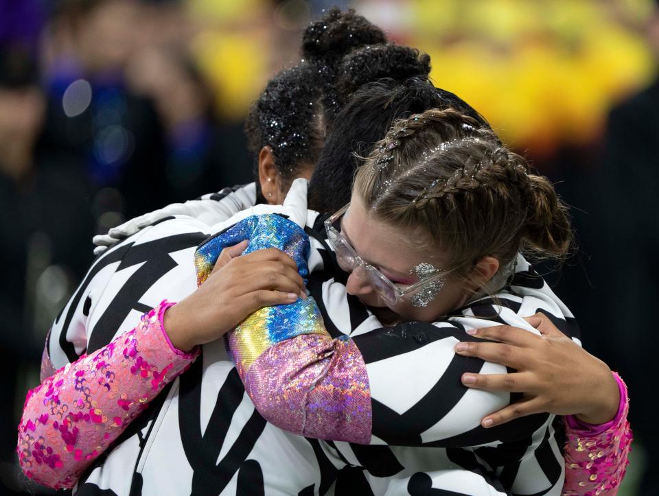 Members of the Edgewood Marching Mustangs celebrate after winning the state final during the ISSMA State Marching Band Finals on Saturday, Nov. 5, 2022, at Lucas Oil Field. 