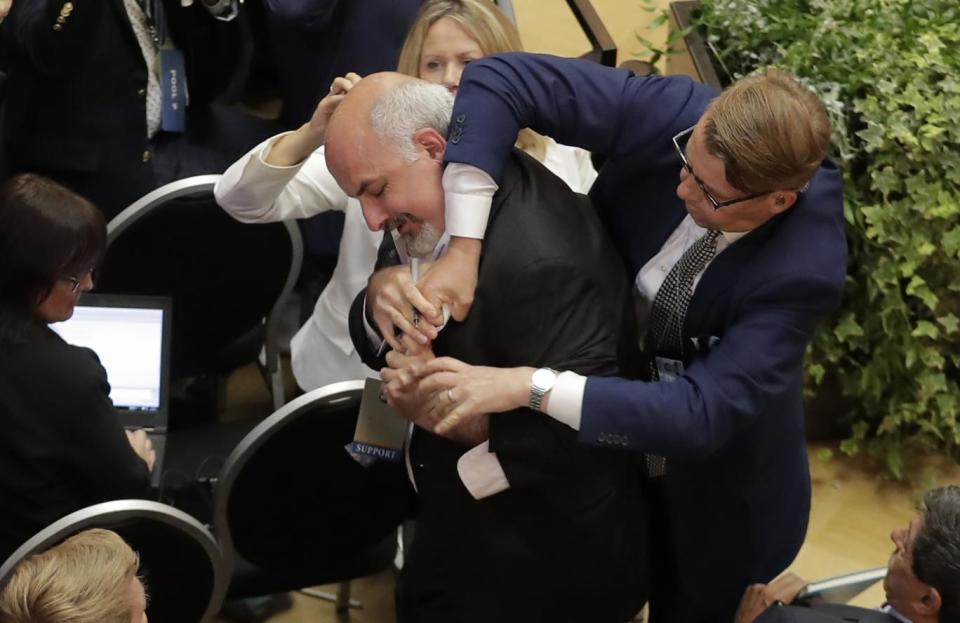 The moment the man was bundled from the room in Russia (AP)