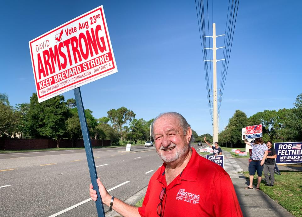 David Armstrong, candidate for the District 4 seat on the Brevard County Commission, does some sign-waving alongside Wickham Road near Suntree United Methodist Church.