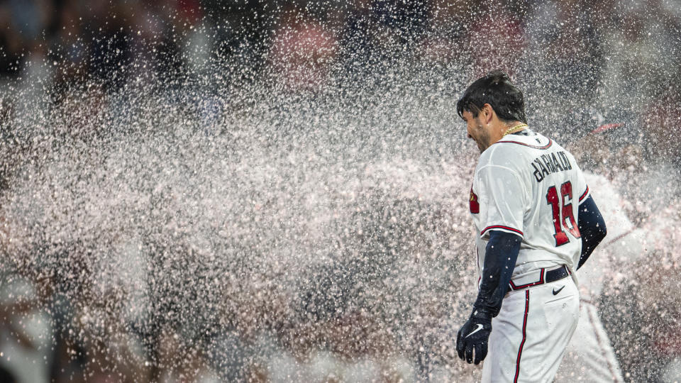 Atlanta Braves Travis d'Arnaud is doused after a walk off single in the eleventh inning of a baseball game against the Houston Astros Saturday, Aug. 20, 2022, in Atlanta. (AP Photo/Hakim Wright Sr.)