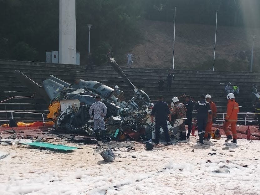 Rescuers work on one of the crashed helicopters.