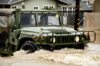 An emergency responder drives through floodwaters in the community of Pajaro in Monterey County, Calif., on Tuesday, March 14, 2023. (AP Photo/Noah Berger)