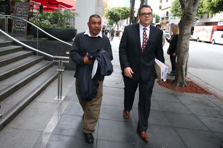 Mario Vargas-Lopez, 45, (L) walks out of immigration court with his lawyer Alex Galvez in Los Angeles, California, U.S., March 22, 2017. REUTERS/Lucy Nicholson