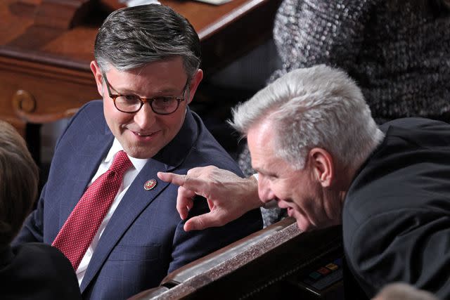 <p>TOM BRENNER/AFP via Getty</p> House Speaker-Designate Mike Johnson speaks with former House Speaker Kevin McCarthy before the Oct. 25, 2023, floor vote