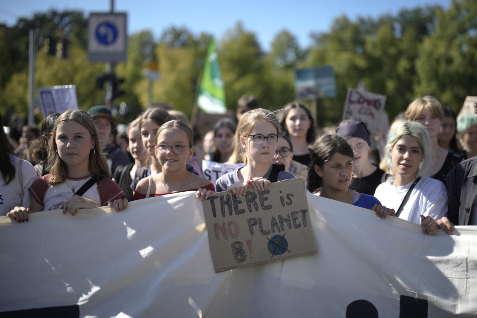 A student holds a poster as she takes part in a Global Climate Strike 'Fridays For Future' protest in Berlin, Germany, Friday, Sept. 15, 2023. Tens of thousands of climate activists around the world are set to march, chant and protest Friday to call for an end to the burning of planet-warming fossil fuels as the globe continues to suffer dramatic weather extremes and topple heat records. (AP Photo/Markus Schreiber)