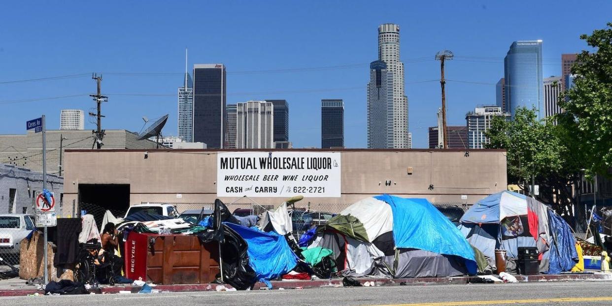 Tents housing the homeless line a street in downtown Los Angeles, California on April 22, 2020, amid the novel coronavirus pandemic.