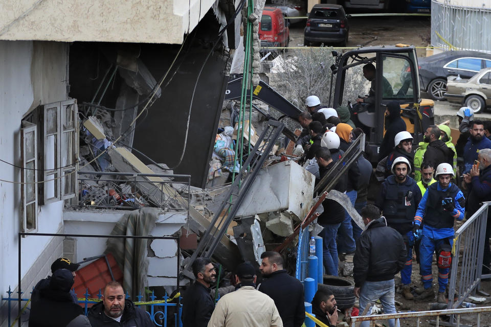 Civil defense and rescue workers remove rubbles from a building that was attacked Wednesday night by an Israeli airstrike, in Nabatiyeh town, south Lebanon, Thursday, Feb. 15, 2024. The airstrike killed several people, Lebanon's state news agency reported. (AP Photo/Mohammed Zaatari)