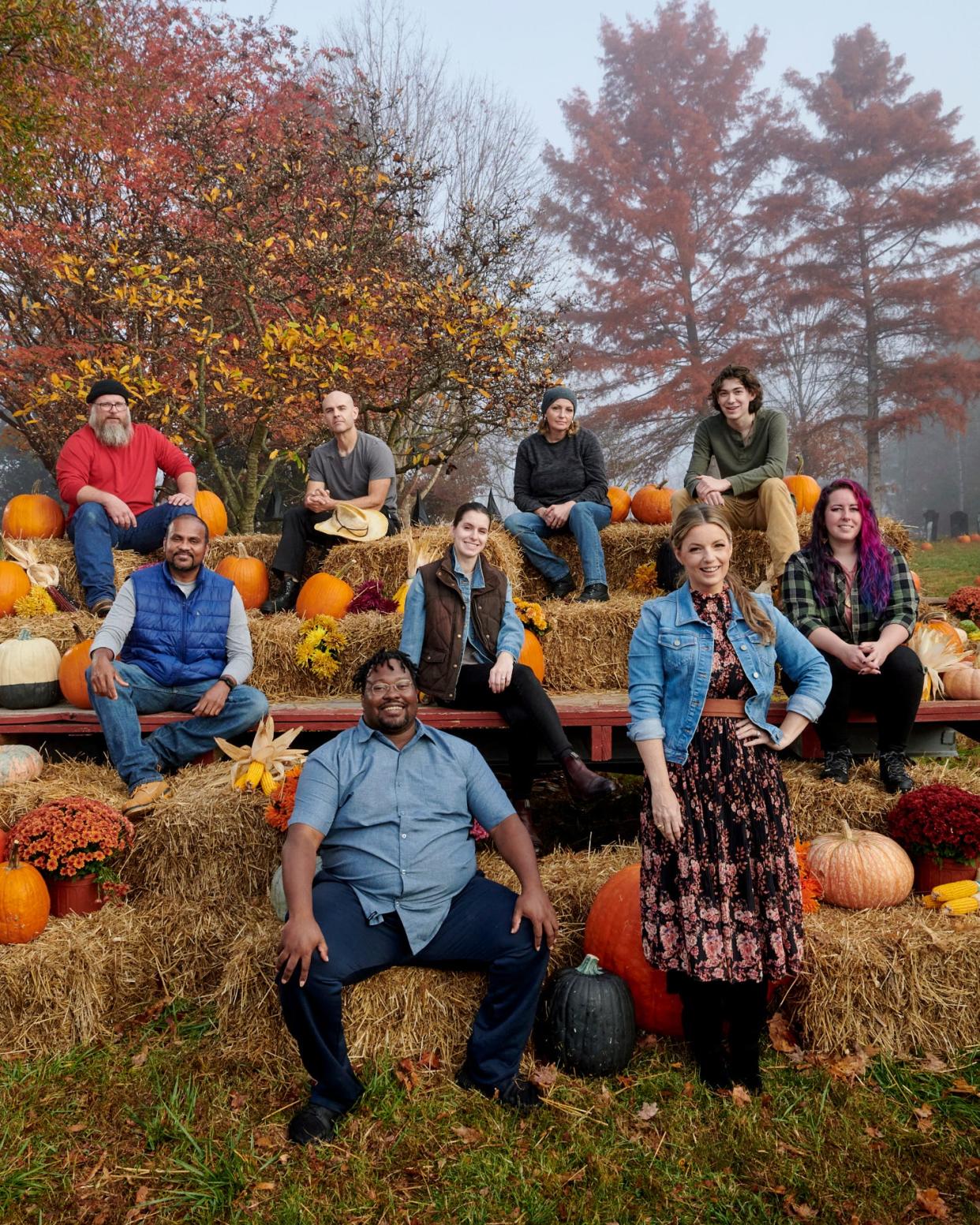 Group portrait of contestants (from top left): Daniel Miller, James Hall, Michele Vanderpyle-Hall, Ethan Anderson, Chaminda Weerappulige, Cassie Remillard, Rebecca DeGroot and Arthur Romeo with host Damaris Phillips as seen on "Outrageous Pumpkins" Season 4.