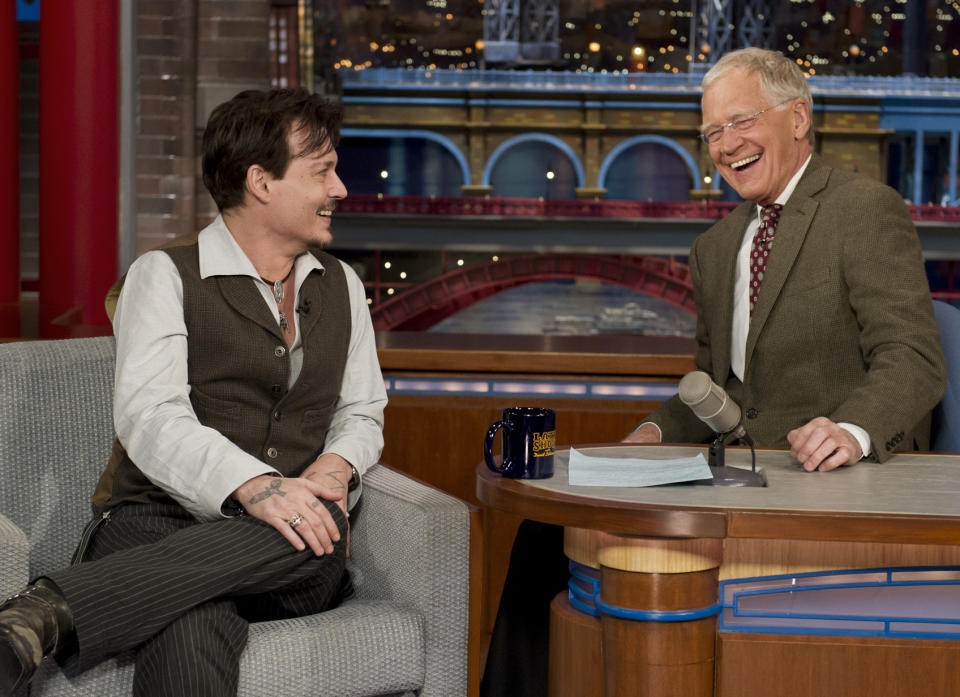 In this photo provided by CBS, actor Johnny Depp, left, joins host David Letterman on the set of the “Late Show with David Letterman,” Thursday, April 3, 2014, in New York. Earlier during Thursday’s taping, Letterman informed the audience that he will retire in 2015, at the end of his current contract. Letterman steps down with the longest tenure of any late-night talk show host in U.S. television history. (AP Photo/CBS, Jeffrey R. Staab) MANDATORY CREDIT, NO SALES, NO ARCHIVE, FOR NORTH AMERICAN USE ONLY