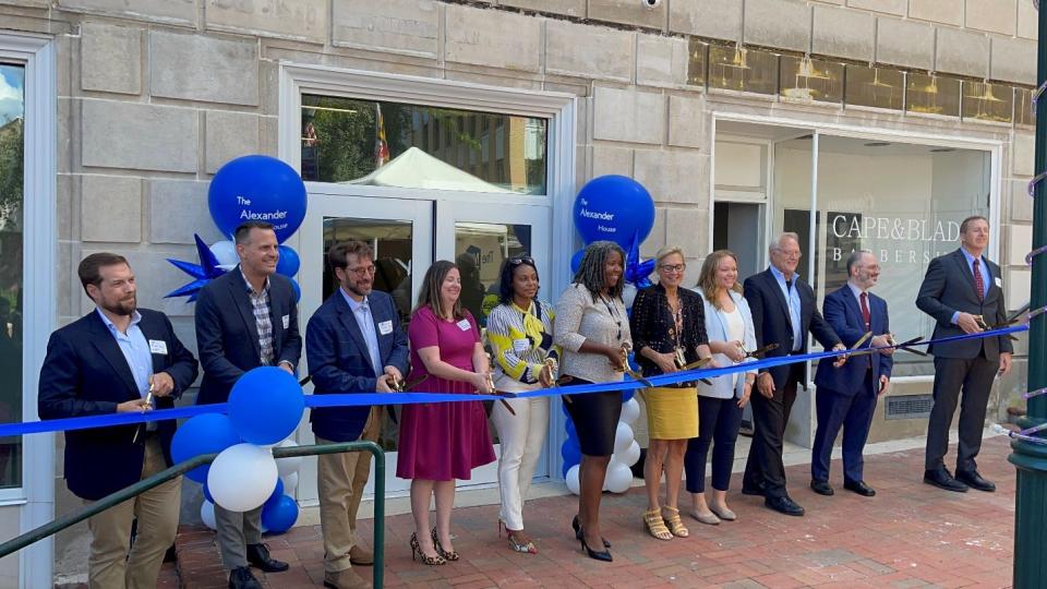 Officials and dignitaries cut the ribbon to reopen Alexander House on Public Square in Hagerstown. From left, Brett Ruby, NHPF; Ken White, Operation Pathways; Scott Barkan, NHPF; Karrie Hawbaker, Alexander House community manager; Geanna Franqui, NHPF; Hagerstown Mayor Tekesha Martinez; Nan Mann, office of U.S. Sen. Chris Van Hollen; Annaston Cree, office of U.S. Rep. David Trone; Stephen Green, NHPF; Ethan Handelman, HUD; Brien O’Toole, chief of housing production, Maryland Department of Housing and Community Development.