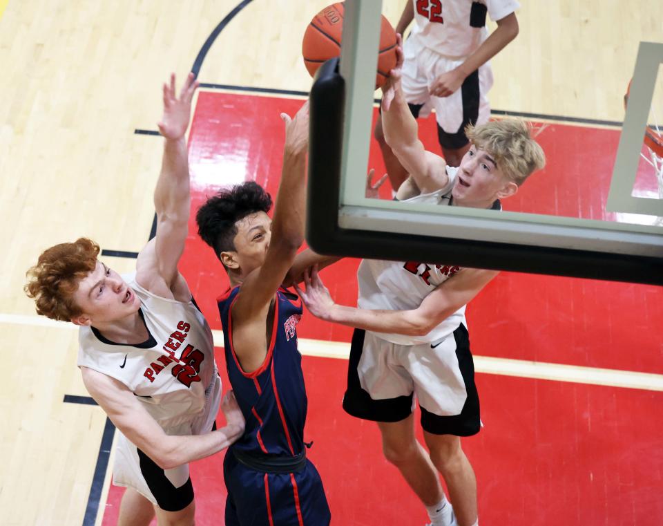 Whitman-Hanson's Ryan Baker blocks the shot of Pembroke's Devanti Perry with teammate Brendan Moore during a game on Tuesday, Dec. 13, 2022.