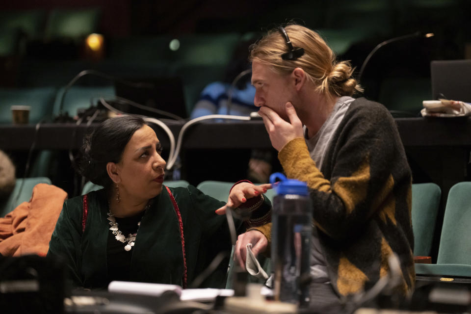 Director Roya Sadat, left, confers with associate stage director Anderson Nunnelley before a dress rehearsal for the opera "A Thousand Splendid Suns," in Seattle, on Wednesday, Feb. 22, 2023. Born in the city of Herat, Afghanistan, she happened to be in the U.S. when she learned that her birthplace had fallen to the Taliban in 2021. (AP Photo/Stephen Brashear)