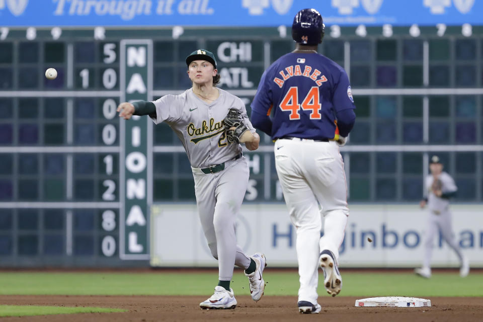Oakland Athletics second baseman Zack Gelof, left, attempts the double play in front of Houston Astros runner Yordan Alvarez (44) during the eighth inning of a baseball game Wednesday, May 15, 2024, in Houston. (AP Photo/Michael Wyke)