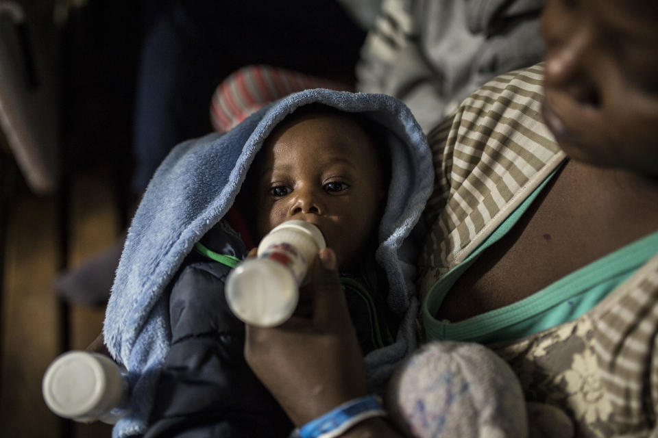 A migrant woman feeds her baby aboard the deck of the Spanish NGO Proactiva Open Arms rescue vessel, after being rescued Dec. 21, in the Central Mediterranean Sea, before disembarking in the port of Crinavis in Algeciras, Spain, Friday, Dec. 28, 2018. The Proactiva Open Arms aid boat carrying over 300 migrants rescued at sea, has ended a weeklong journey across the western Mediterranean Sea to dock at the Spanish port of Algeciras on Friday. .(AP Photo/Olmo Calvo)