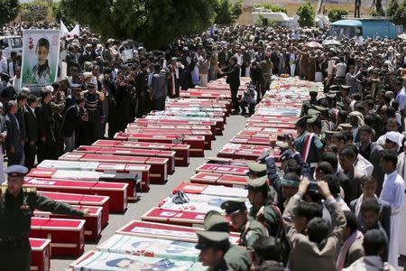 People gather around the coffins of victims of suicide attacks during a mass funeral procession in Sanaa March 25, 2015. REUTERS/Khaled Abdullah