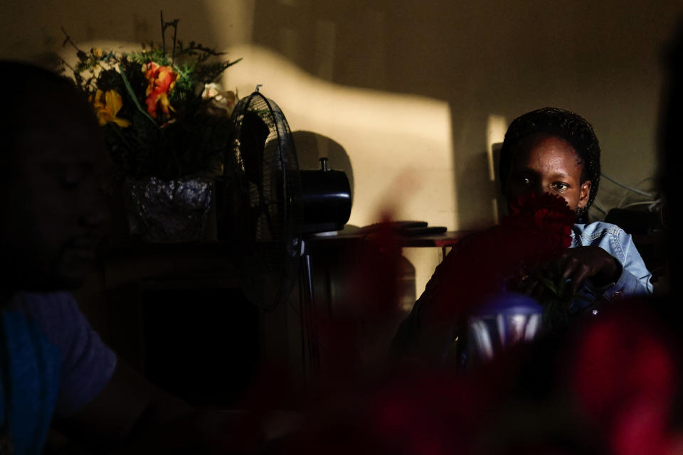 A woman from Haiti sits in a Haitian restaurant, Monday, Sept. 20, 2021, in Tijuana, Mexico. Many Haitians have established at least temporary legal status in Mexico, Brazil and elsewhere. (AP Photo/Gregory Bull)