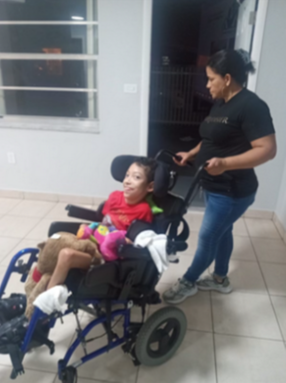 Erika Díaz and her son, 13-year-old José Andino Díaz, walk into their new home, funded by an anonymous Wish Book donor.