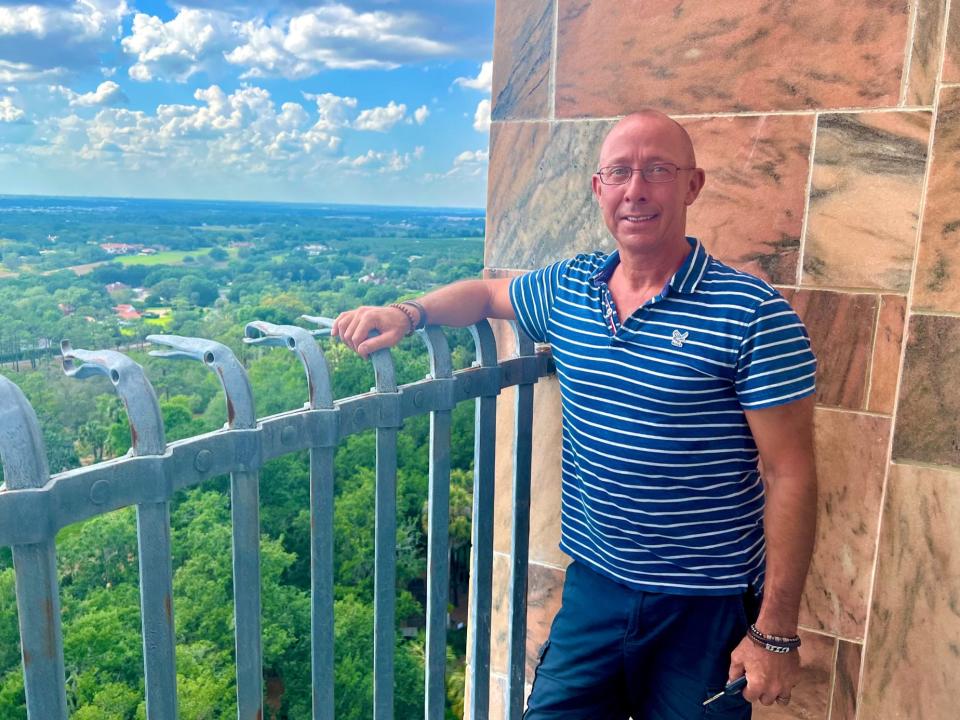 Geert D'hollander, carillonneur at Bok Tower Gardens in Lake Wales, peers from atop the carillon tower across the vast landscape. He said the Bok Tower carillon is unique because "you can play until midnight here and no one will complain."