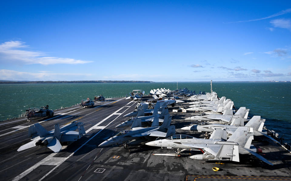 GOSPORT, ENGLAND - NOVEMBER 17: F-18 jet fighters are seen on the flight deck of USS Gerald R. Ford, on November 17, 2022 in Gosport, England. The USS Gerald R. Ford (CVN-78) is the lead ship of her class of United States Navy aircraft carriers. Commissioned in 2017, the carrier is powered by two nuclear reactors with a length of 1,092 feet and displacement of 100,000 long tons full load. With a crew of approximately 4,550, 75+ aircraft and state of the art weaponry, the first-in-class is the US Navy's most advanced aircraft carrier. USS Gerald Ford has been carrying out NATO exercises in the North Atlantic with French and Spanish ships. (Photo by Finnbarr Webster/Getty Images)